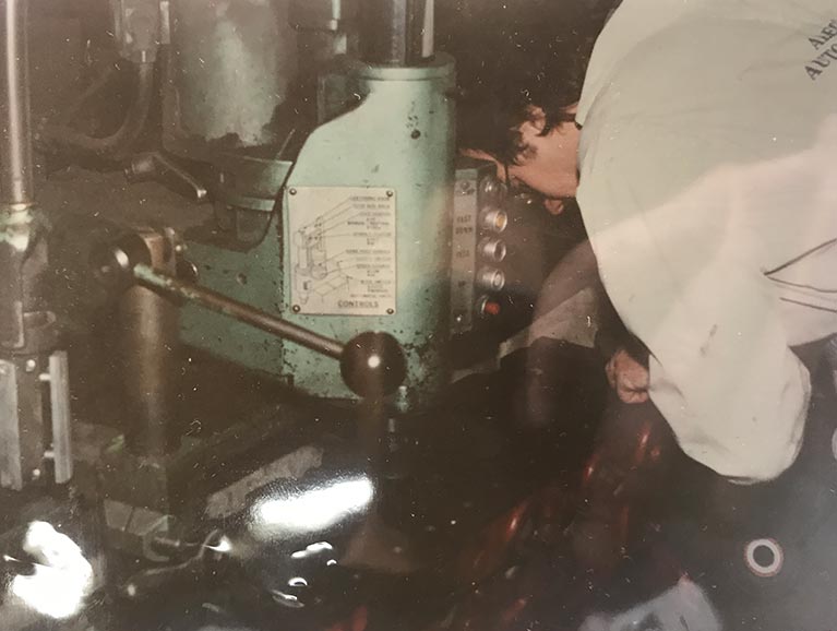 A vintage photo of a worker in Alec's Automotive Shop